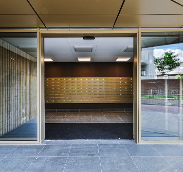 opened glass door leaning into hall modern apartment building city street 13676638 1